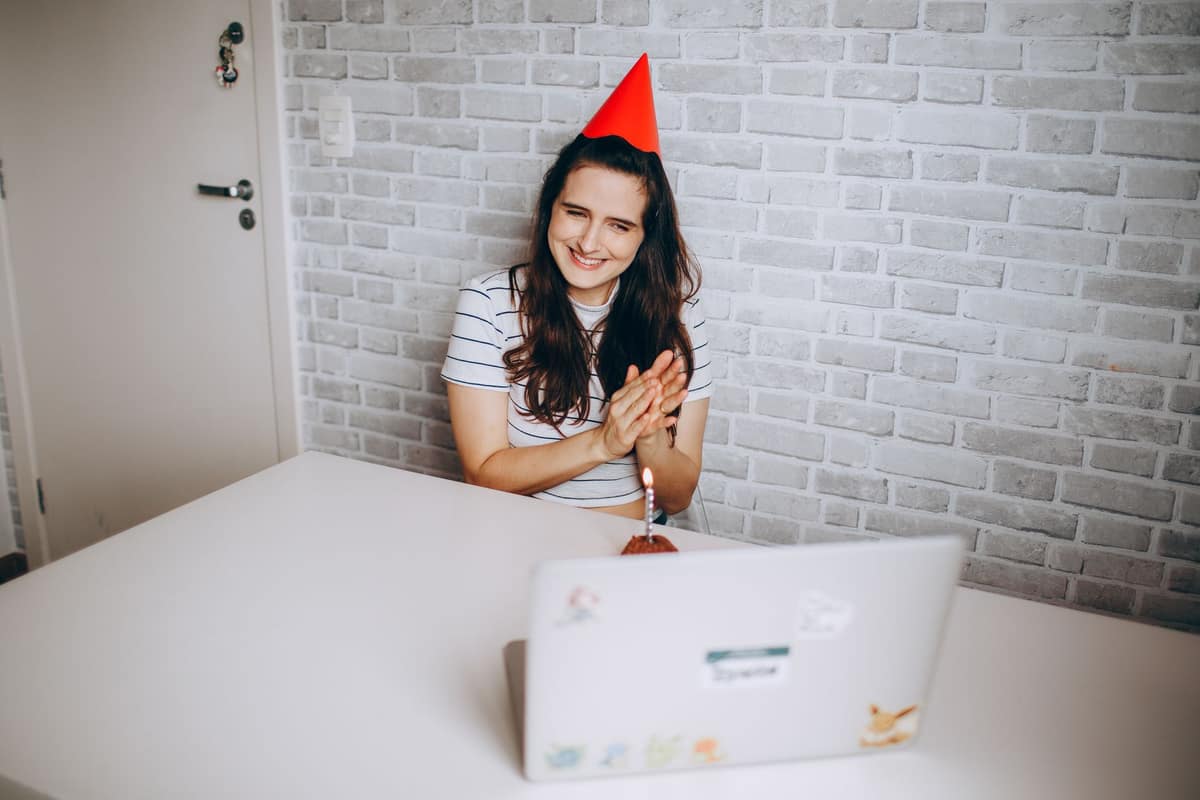 A young woman smiling at a laptop