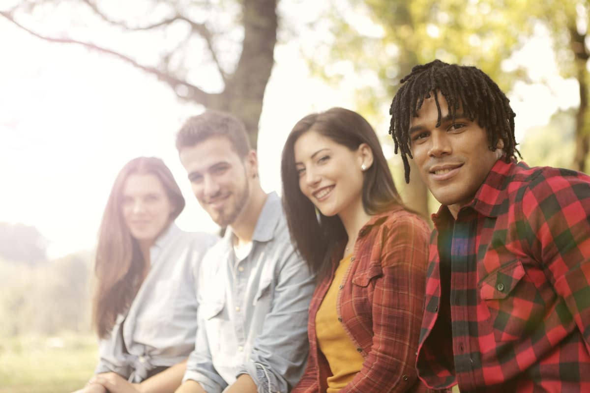 Young adults talking outdoors in bright daylight