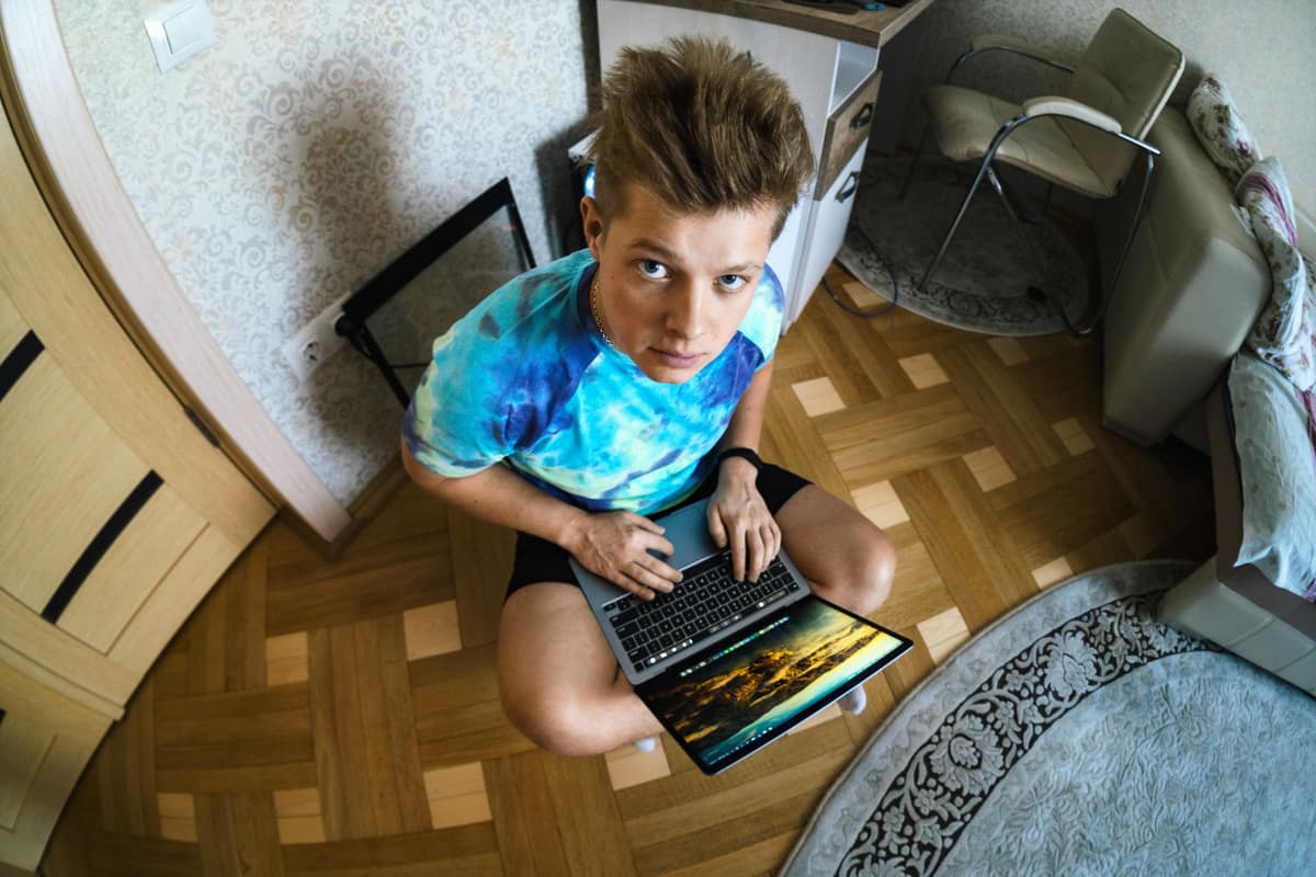 A young person playing a game on a laptop