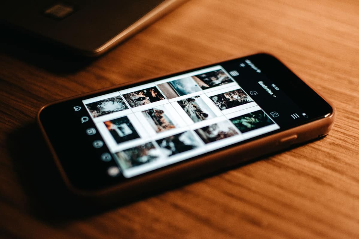 A smartphone showing a photo gallery on a desk