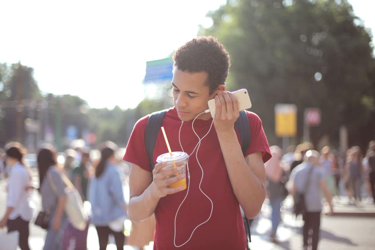 A person listening to headphones while walking outdoors