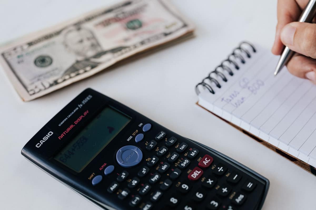 A notebook and calculator on a bright desk