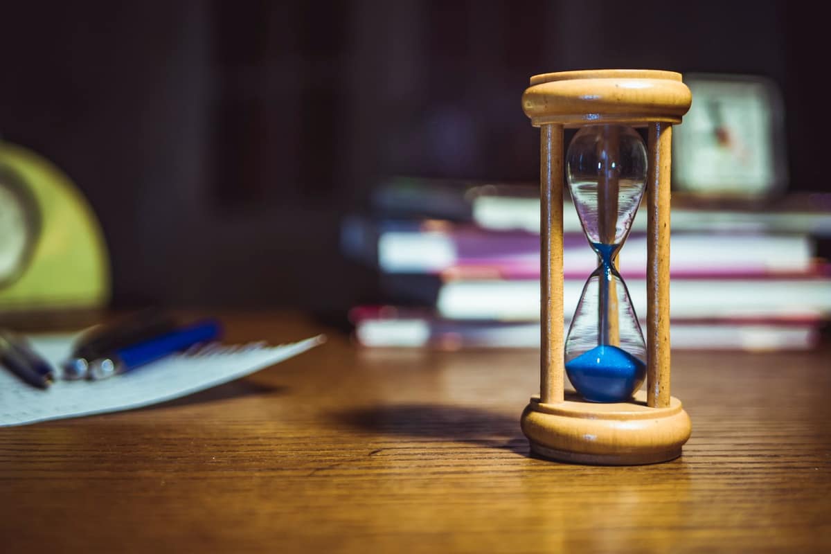 An hourglass on a bright desk