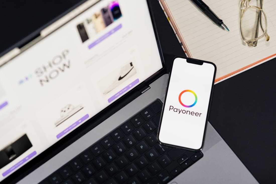 A phone showing a shopping app resting on a bright desk