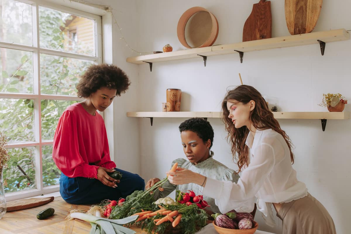 Friends cooking together in a bright kitchen