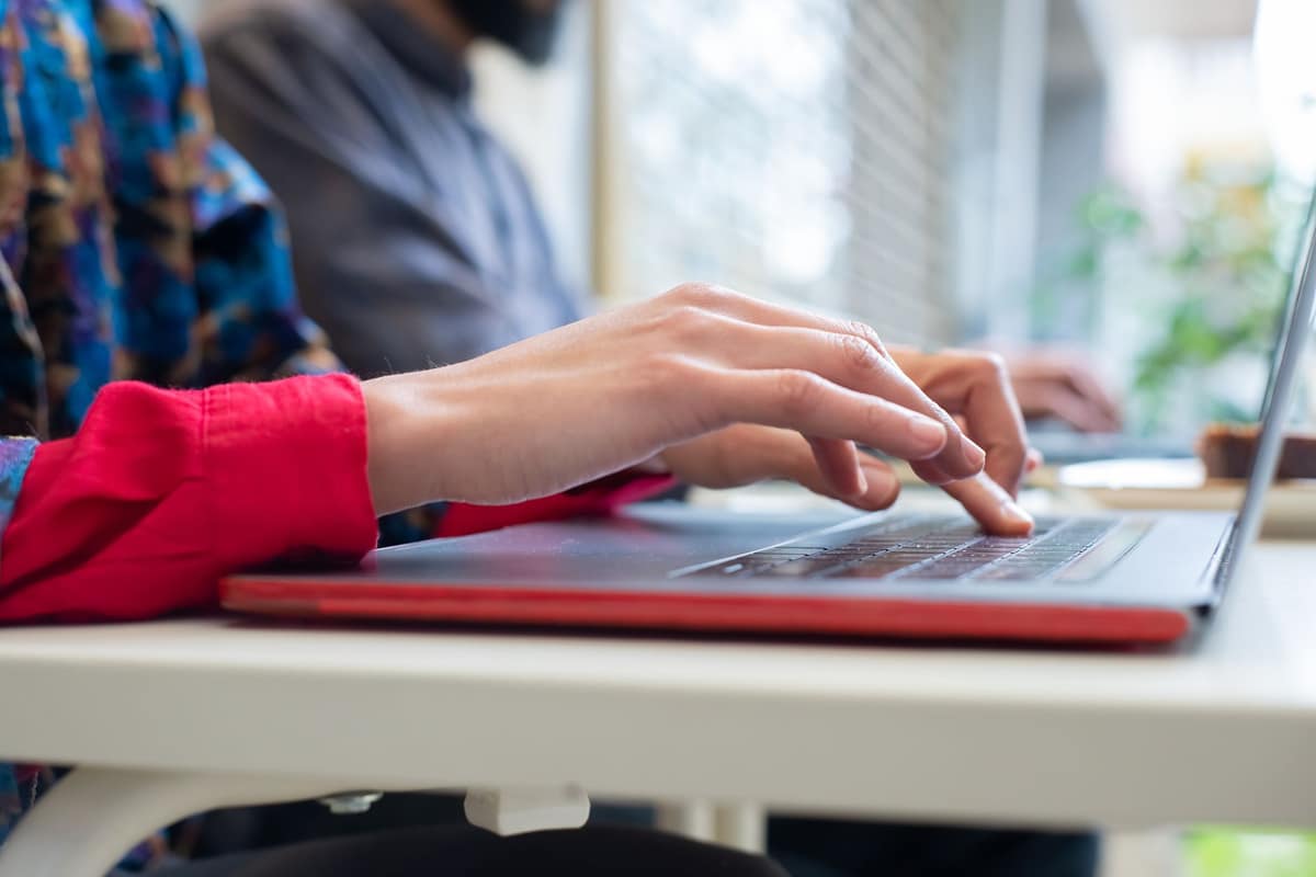 Someone typing an email on a laptop