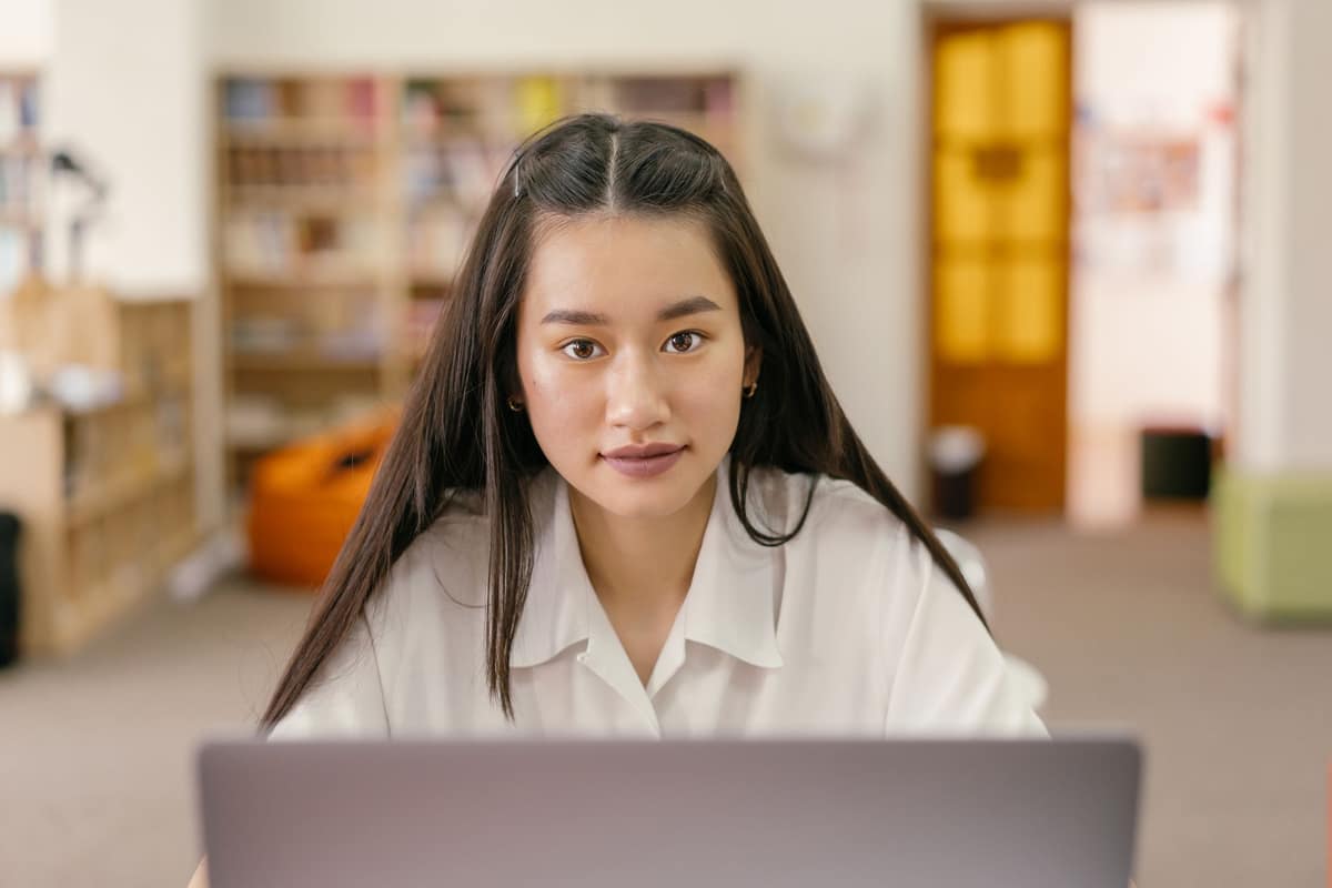 A person signing up on a laptop in a bright room