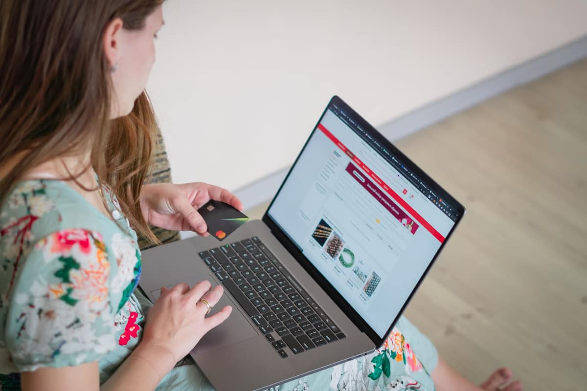 A person shopping online at a bright desk