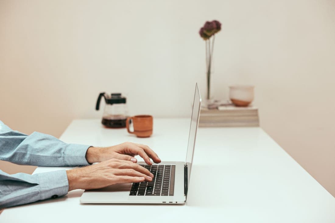 A person reviewing account settings on a laptop at a bright desk