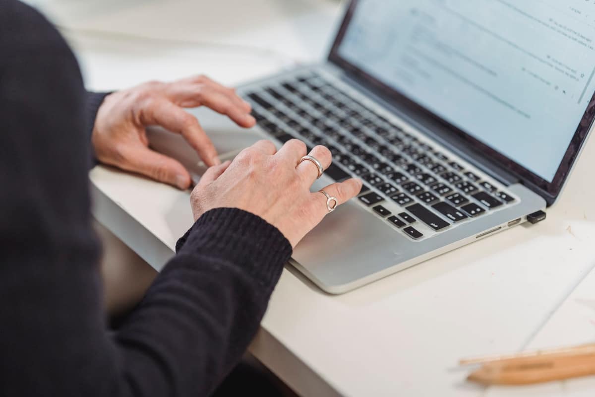 A person working at a laptop in a bright room