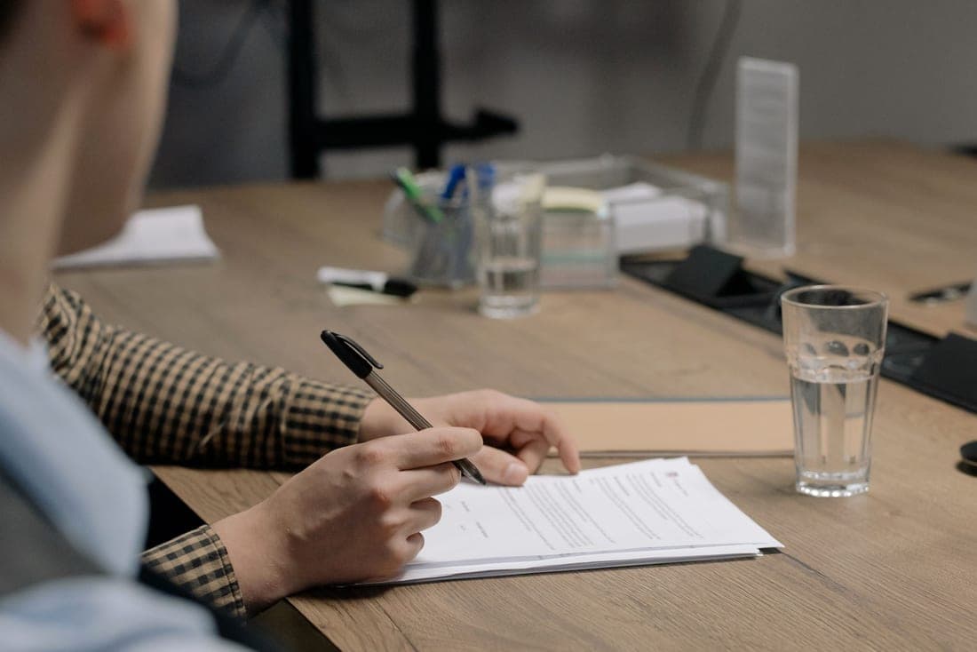 Documents being read at a desk in natural daylight
