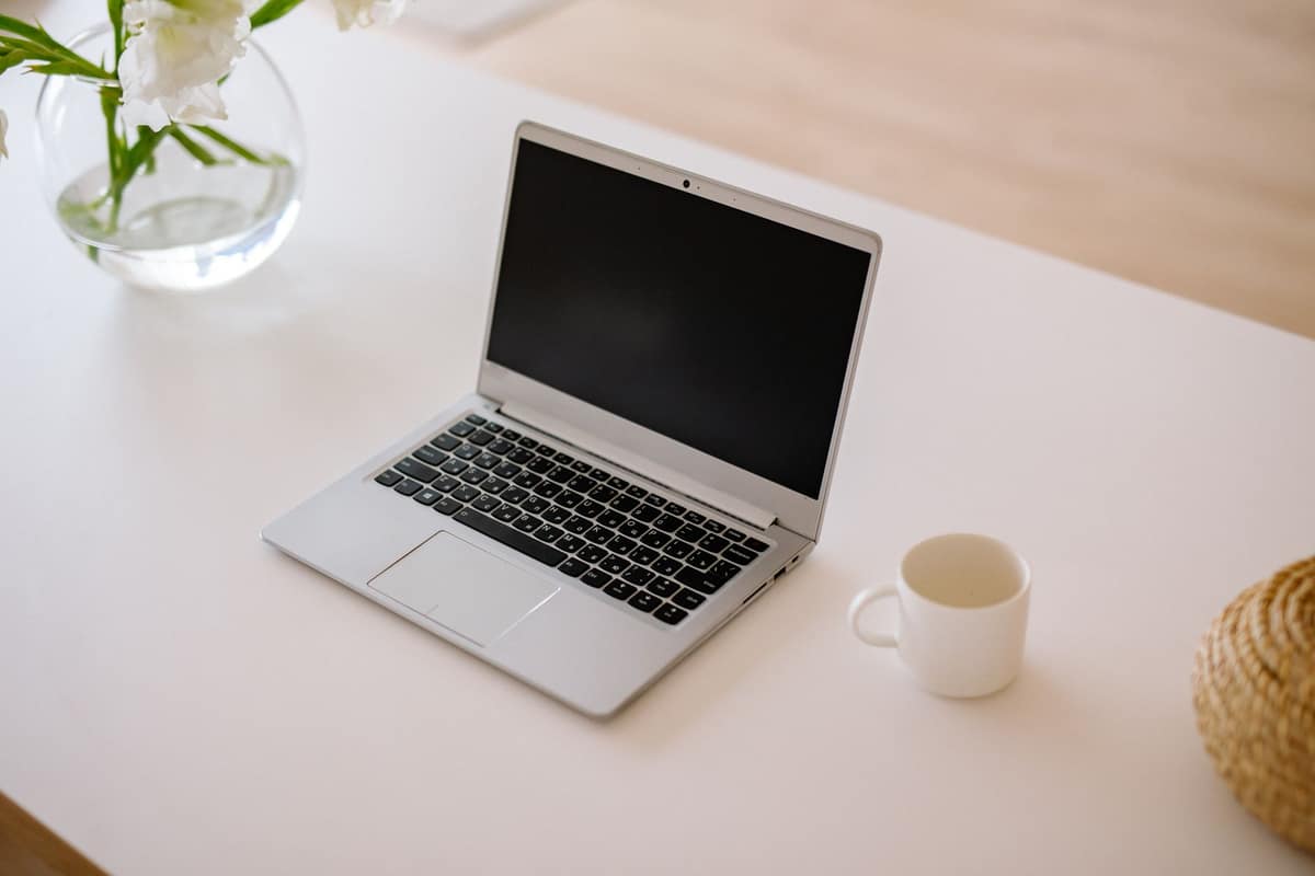 An open laptop on an empty desk