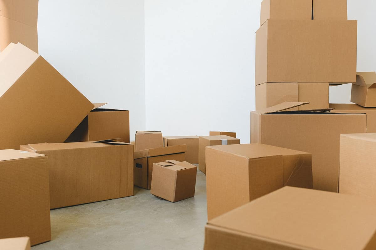 Cardboard delivery boxes stacked in a bright white room