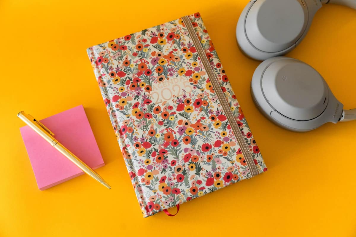 A calendar and planner on a bright desk