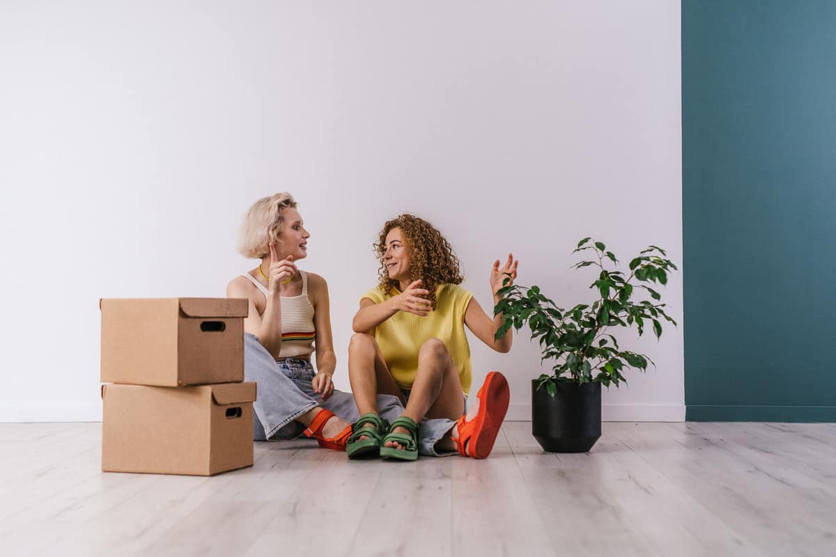 Roommates talking in a bright apartment