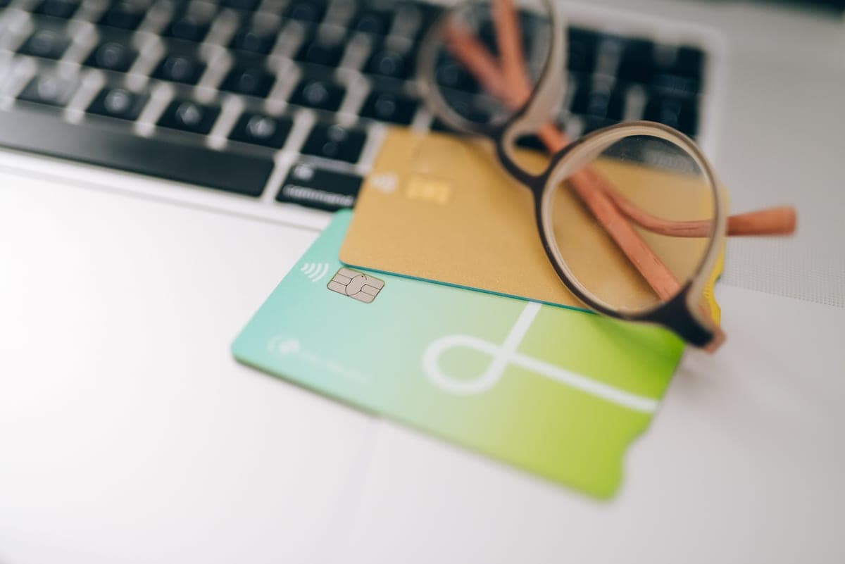 Online shopping on a laptop with a card on a bright desk