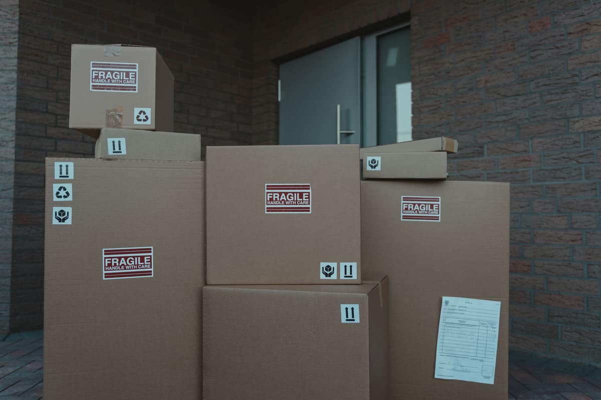 Cardboard delivery boxes on a doorstep in daylight